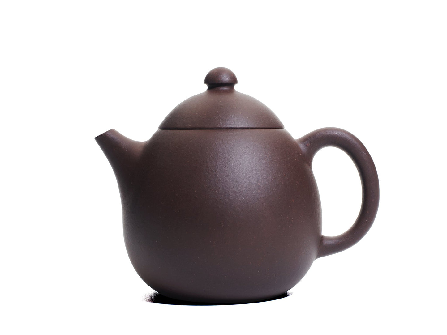 Left side view of the bronze grade Da Long Dan teapot with a gently curving spout and oval body.