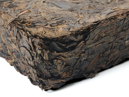 Close-up side view of Fu Brick Tea (茯砖茶) showing compressed leaf texture – traditional dark tea by Cha Zhi Ji and Hui He Tang
