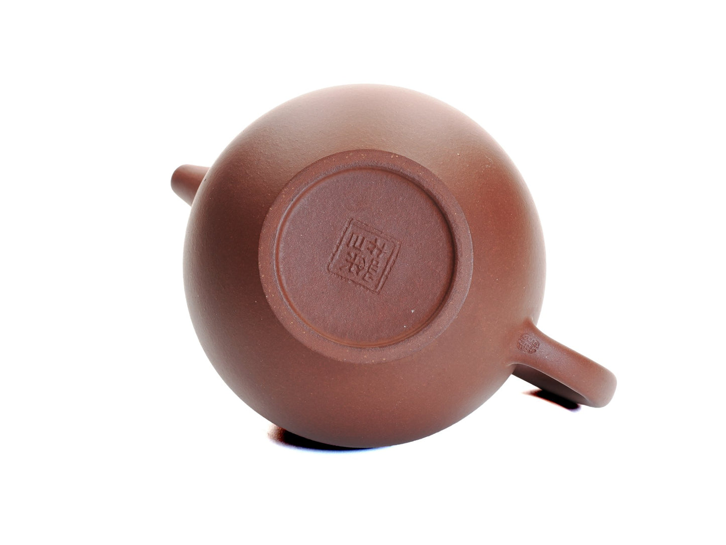 Bottom view of the Hong Pi Long Da Long Dan teapot showing the potter’s seal and smooth foot ring.