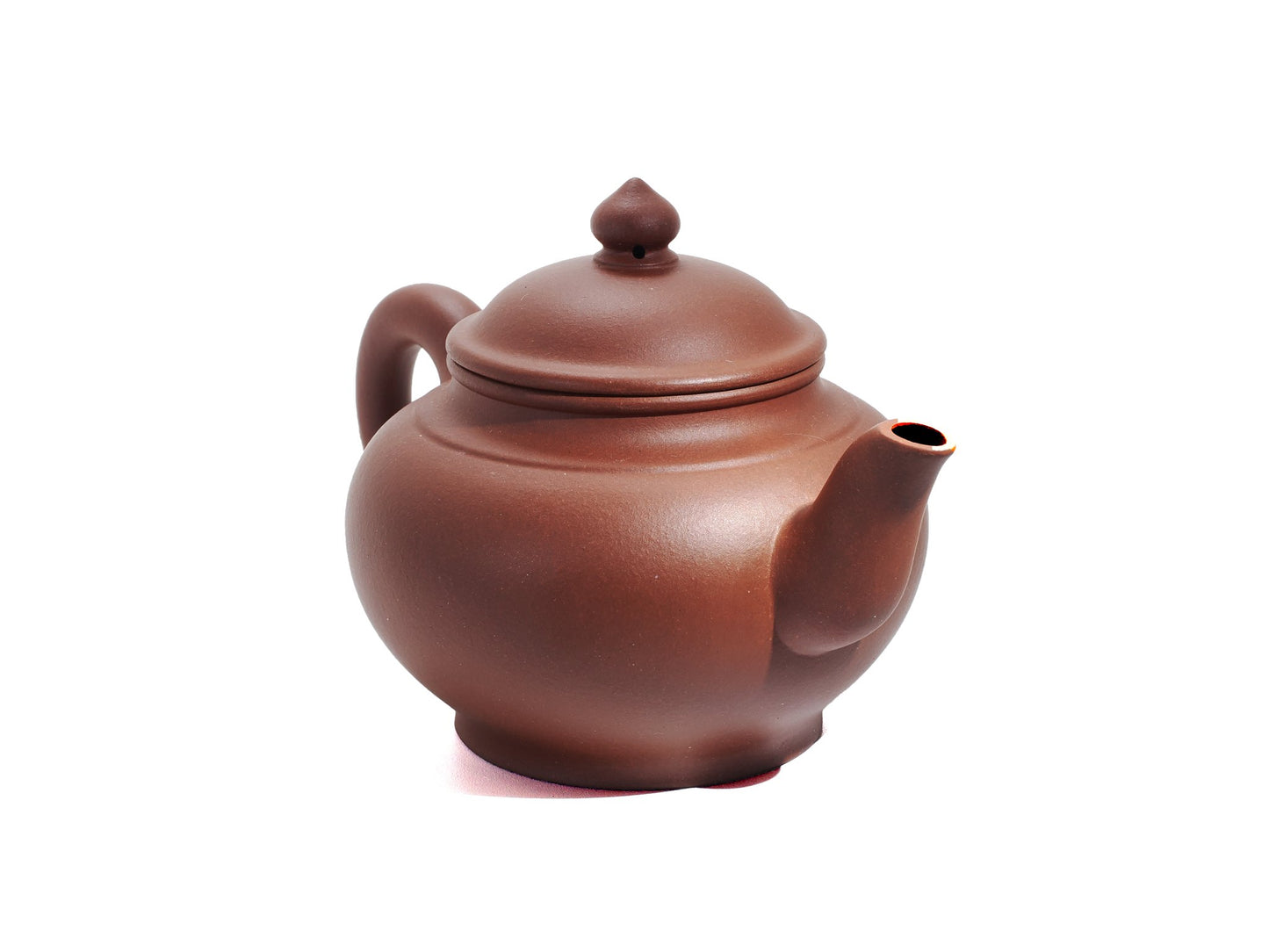 Angled front‑right view of the Xiao Ying Hu teapot displaying its round belly, pointed spout and smoothly polished red clay surface.
