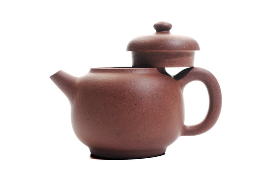 Handmade Xiao Da Bin Yixing teapot with lid removed, showing the 50 ml diamond‑grade purple clay body and ergonomic handle.