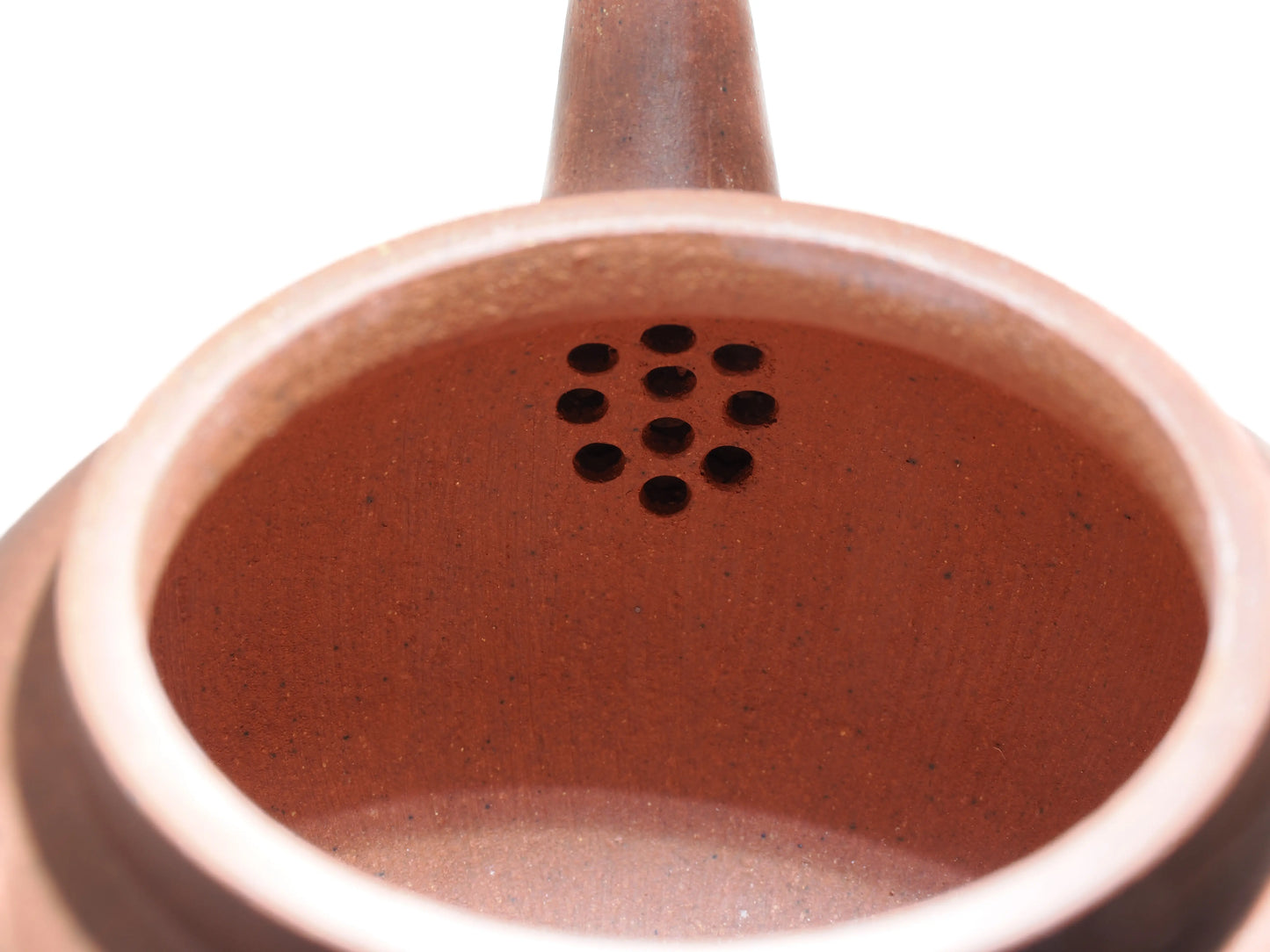 Close-up of the internal filter holes inside the Diamond Grade teapot, showing the clean clay work.