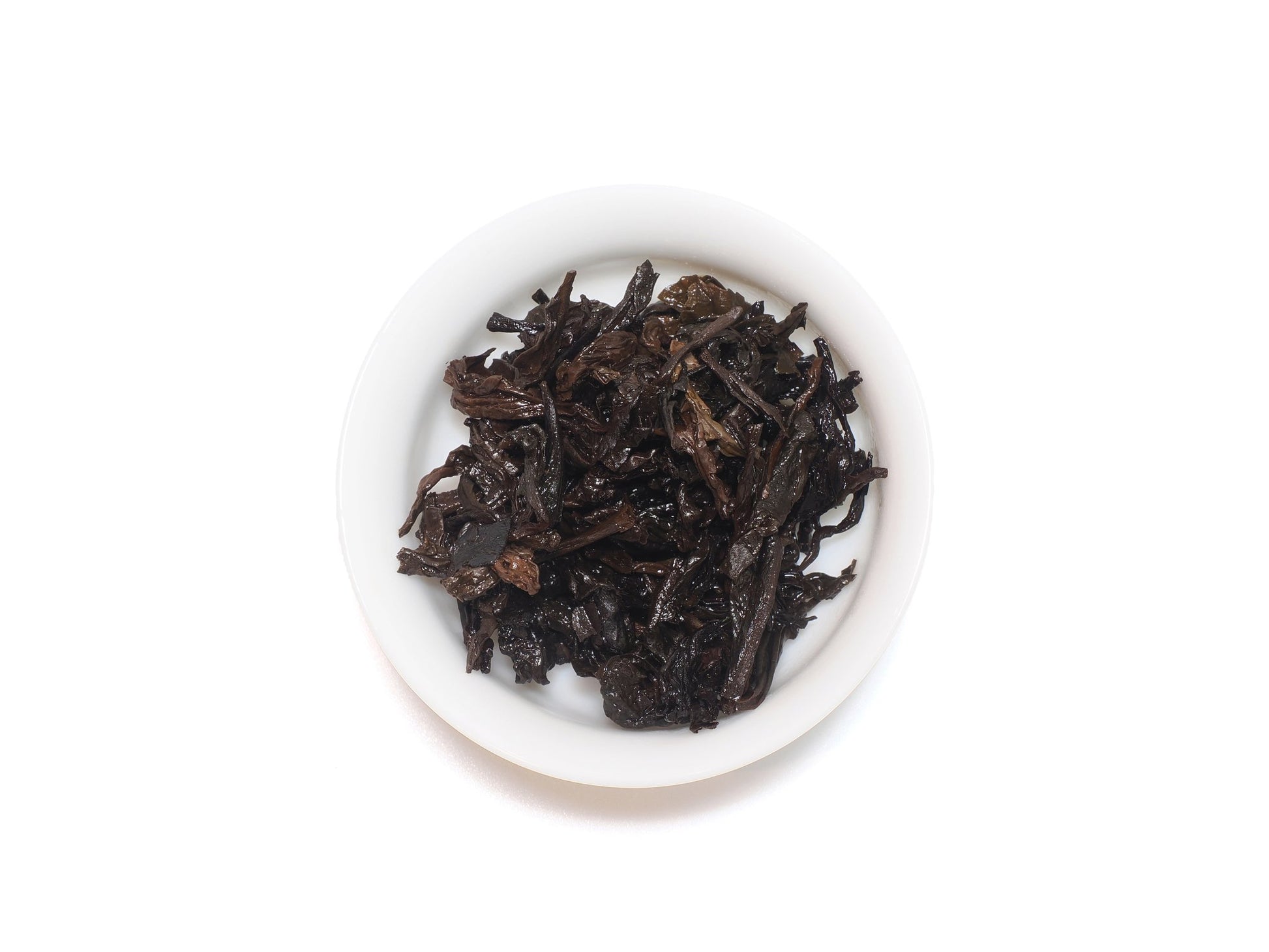 Wet leaves of Lao Cong Shui Xian after infusion in a white teacup