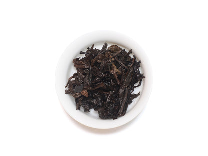 Wet leaves of Lao Cong Shui Xian after infusion in a white teacup