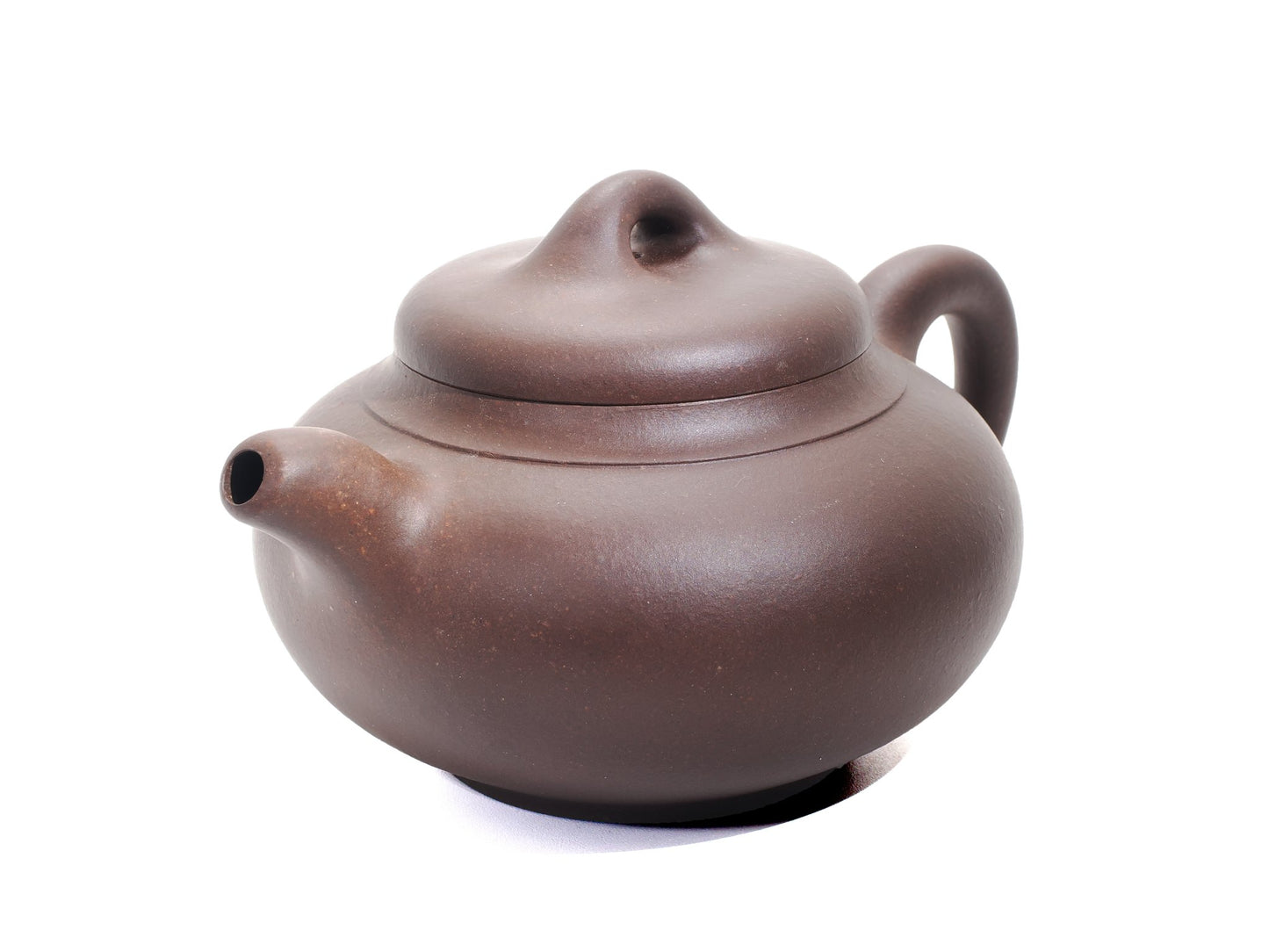 Angled front‑right view of the Yun Tong Hu teapot showing its dark brown bronze‑grade clay and short spout.